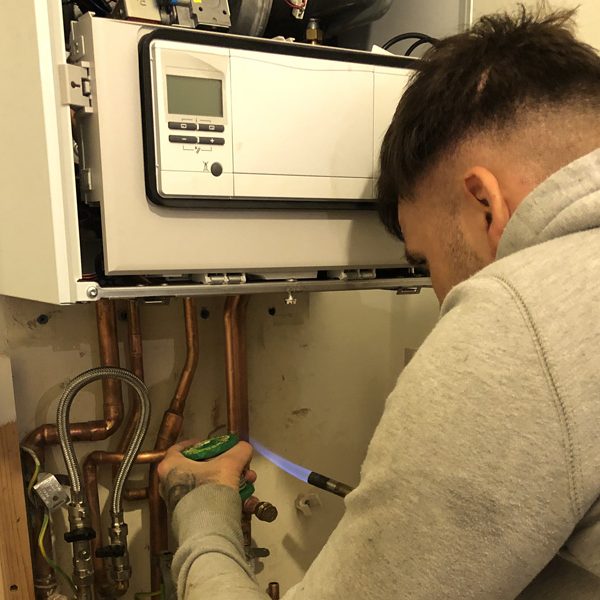 The London Plumbing Company Gas Safe registered engineer carrying out a boiler repair